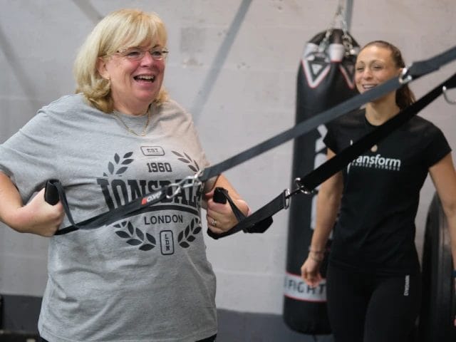 Woman working out with female coach